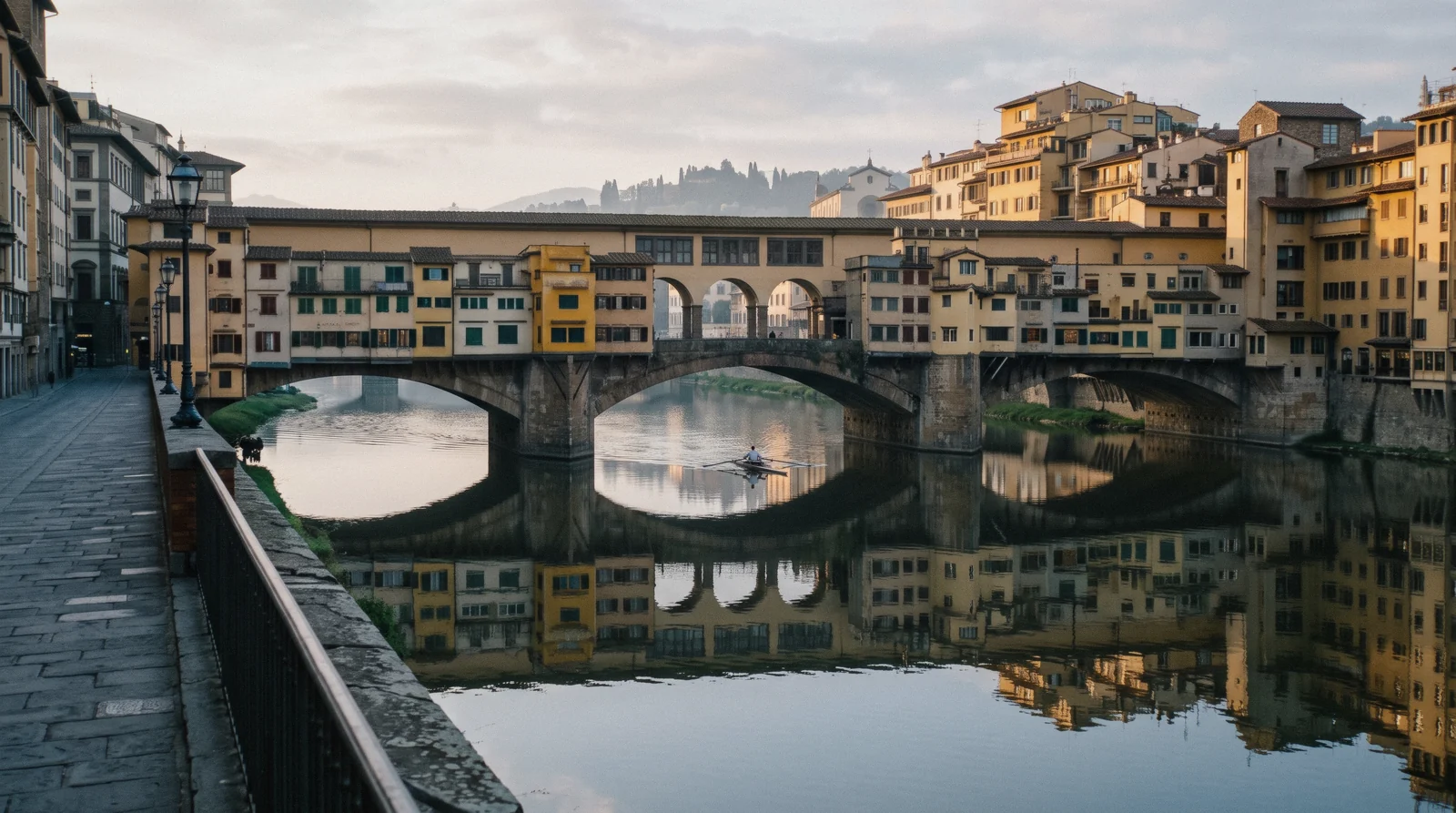 Ponte Vecchio and its ochre shop-backs over a still Arno seen from Ponte Santa Trinita before sunset, Ponte Vecchio Florence
