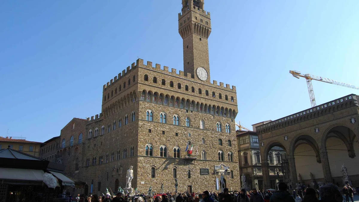 Certified guide leading a small group through Palazzo Vecchio on a guided tour in Florence, Italy