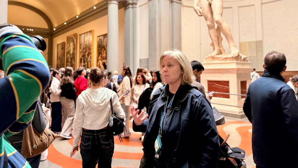 Small group with a guide walking between the Accademia and Uffizi on a Florence museum tour in Italy