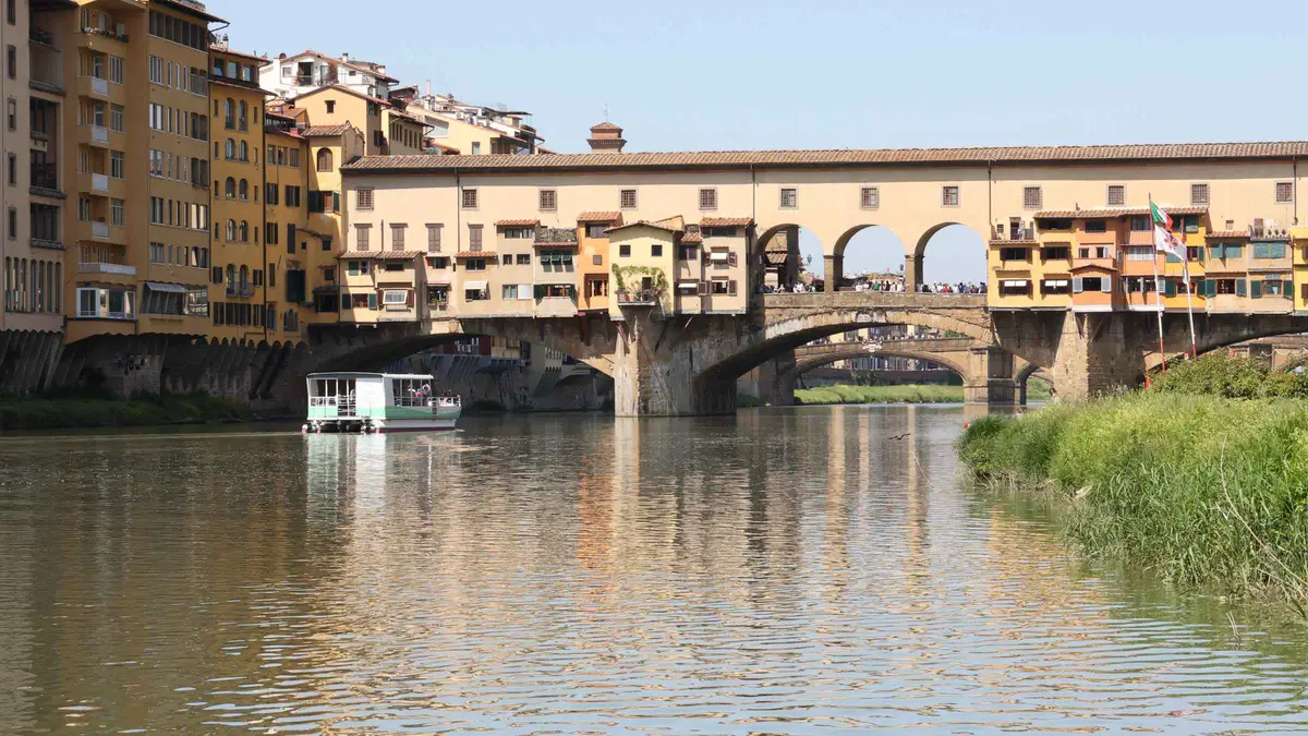 Electric sightseeing boat with commentary on an Arno River cruise in Florence