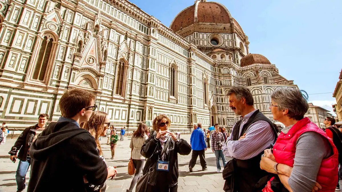 Guide leading a small group past Florence landmarks on a city highlights walking tour
