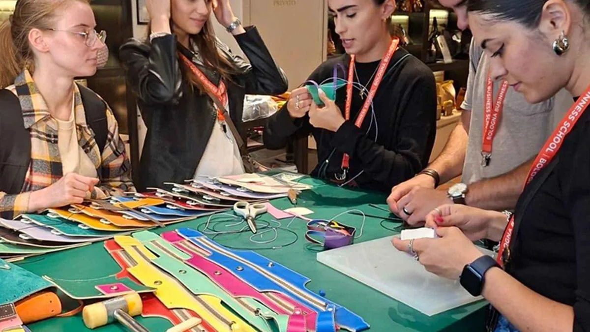 Participant assembling a leather accessory at a Florence leather workshop in Palazzo Gondi