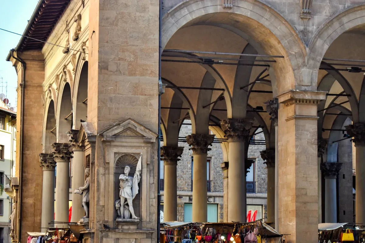 Leather bag stalls under the arches of the Loggia del Mercato Nuovo, one of the Florence markets open every day