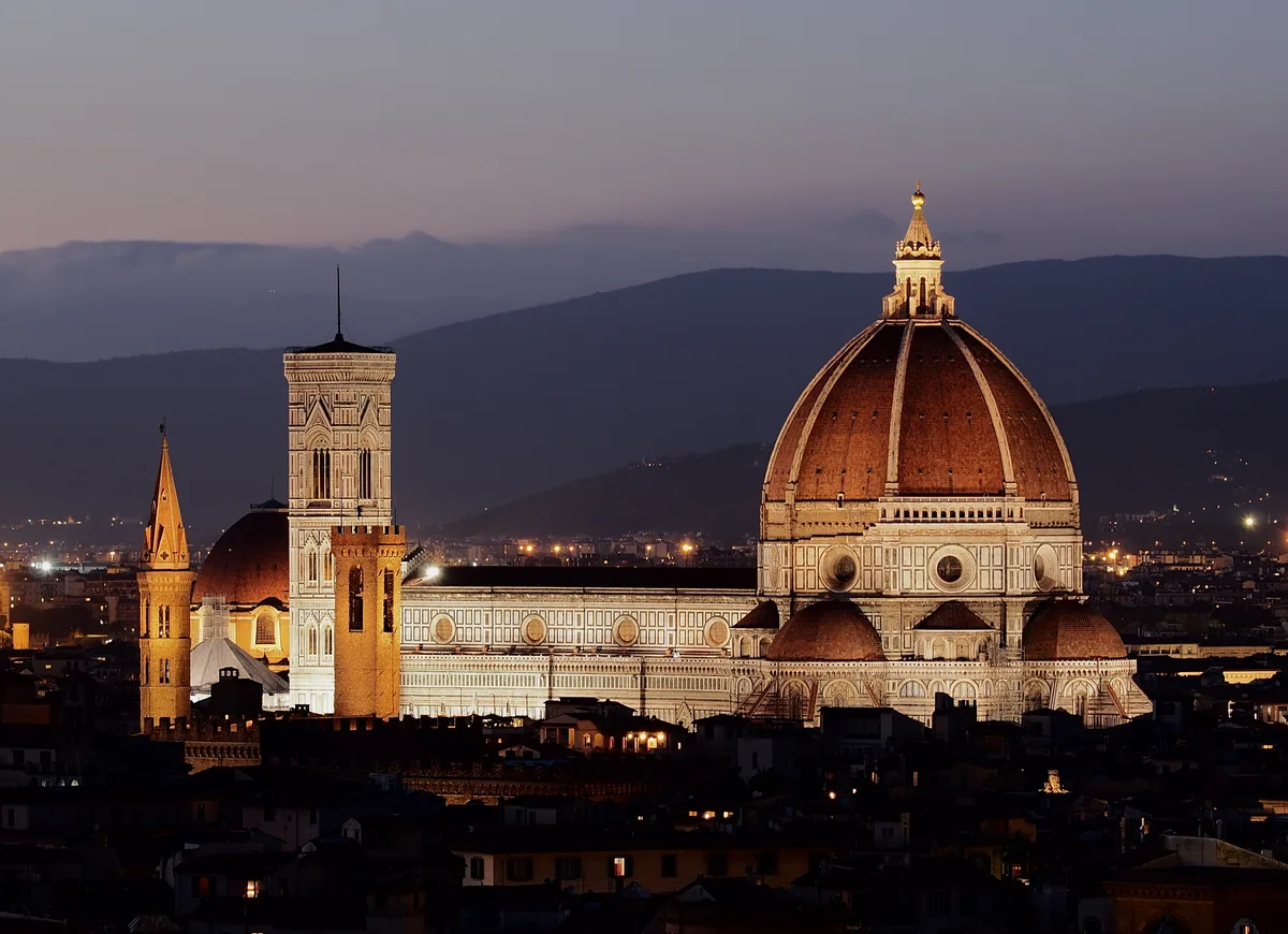 Florence Cathedral lit up at dusk, seen from the hillside by Piazzale Michelangelo