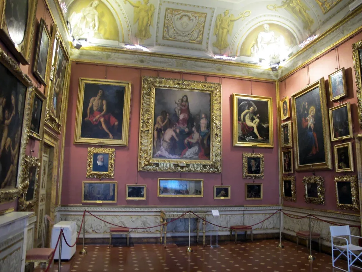 Paintings hung frame to frame in the Sala di Ulisse of the Palatine Gallery inside Pitti Palace, Florence